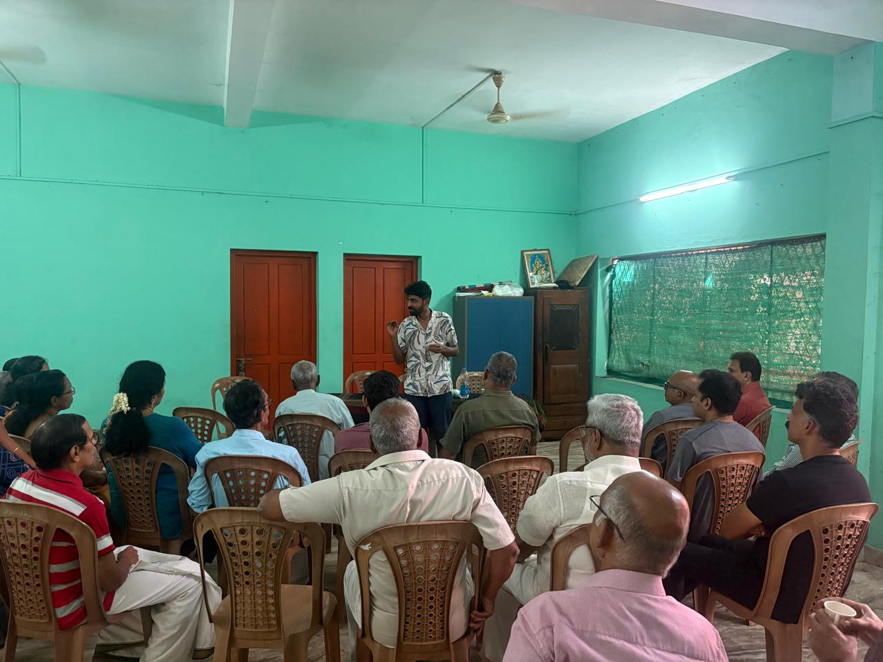 An Arike volunteer talking with a community group